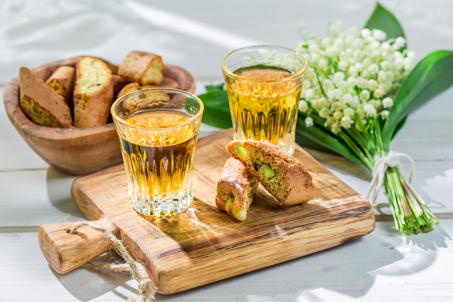 Delicious biscotti with wine on old wooden table